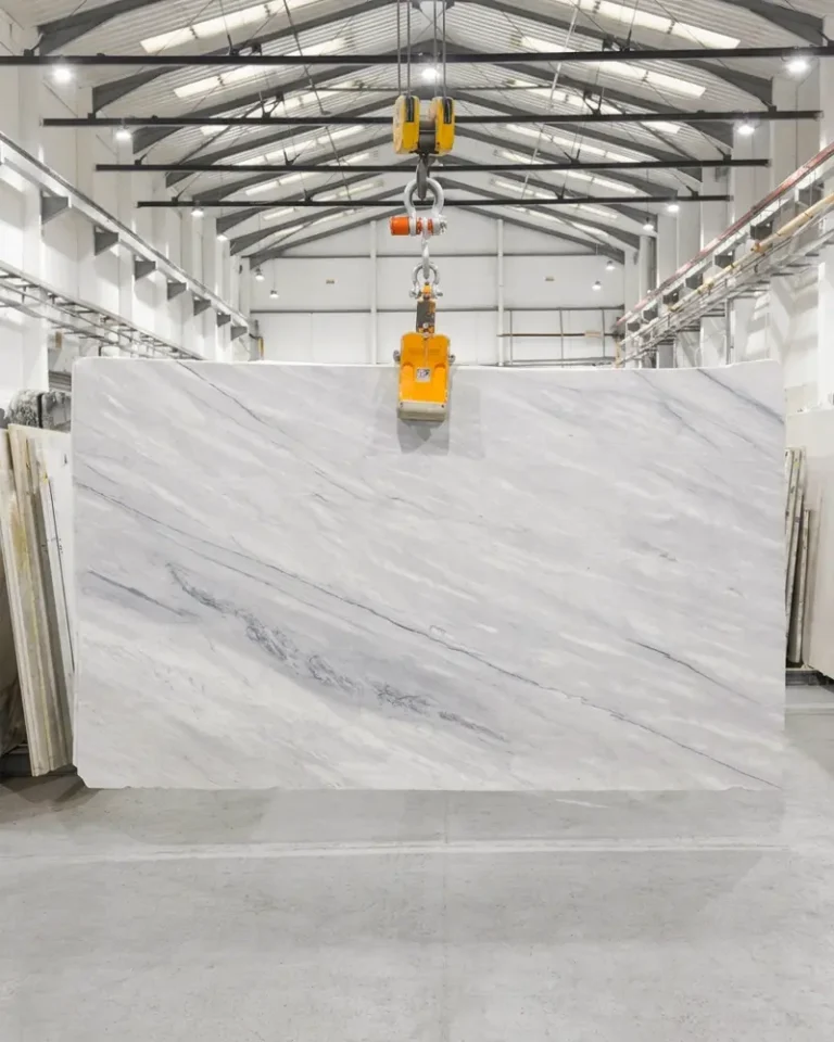 Carrara polished marble slab with soft white background and delicate natural grey veining